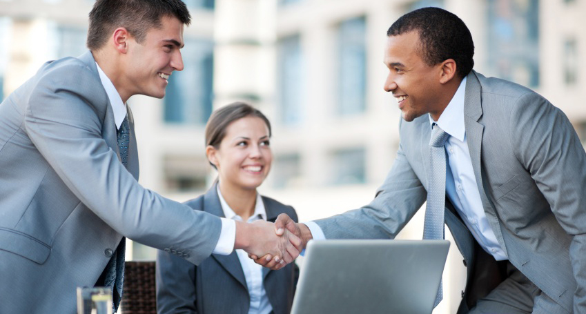 Young business people making a business deal.